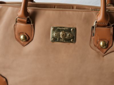Damaged leather handbag with wear and tear