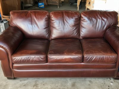 Faded and cracked leather furniture before professional restoration